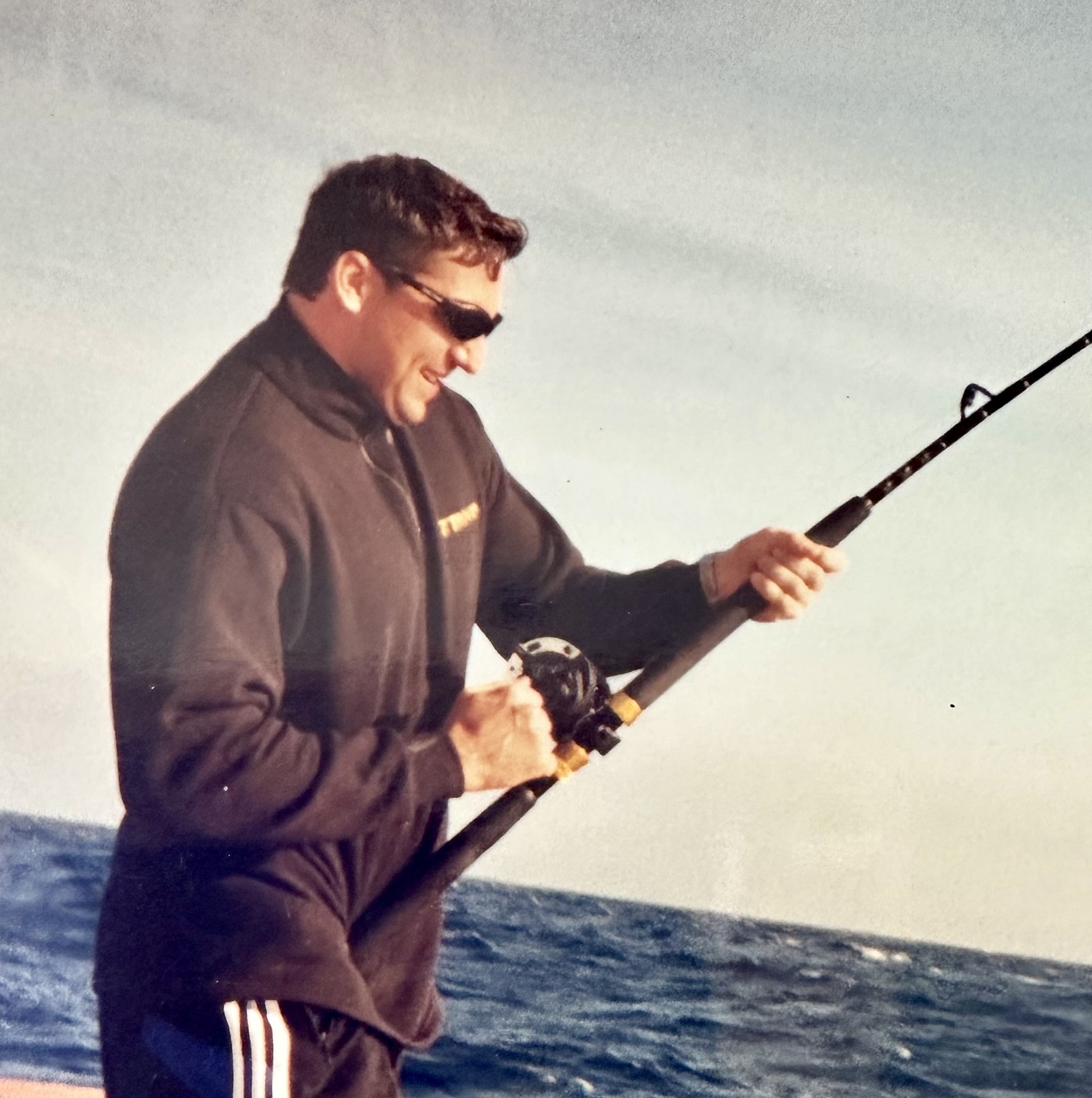 An angler fishing beside the boat